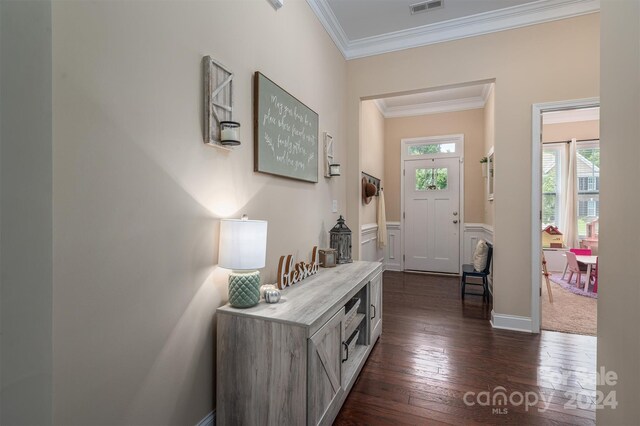 interior space featuring dark wood-type flooring and crown molding