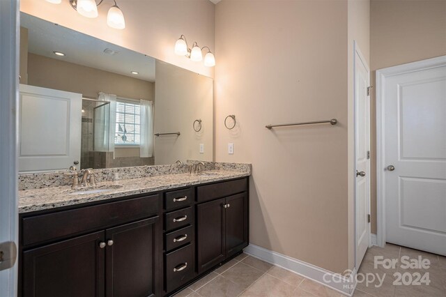 bathroom featuring dual vanity and tile patterned floors