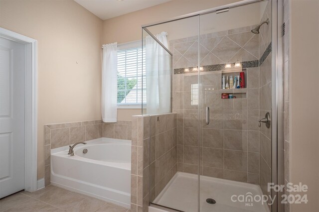 bathroom with tile patterned floors and separate shower and tub