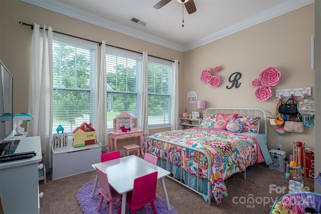 bedroom with carpet flooring, crown molding, and ceiling fan