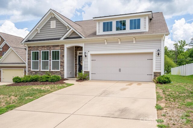 craftsman-style house with a garage and a front yard