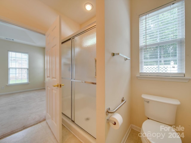 bathroom with walk in shower, tile patterned floors, and toilet