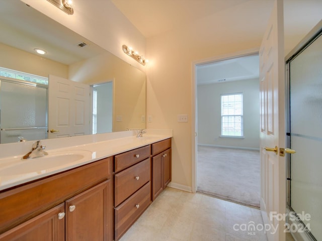 bathroom with tile patterned floors and dual bowl vanity