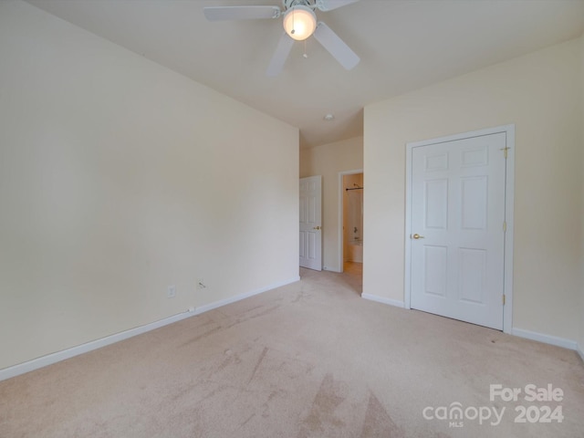 unfurnished bedroom featuring light carpet and ceiling fan