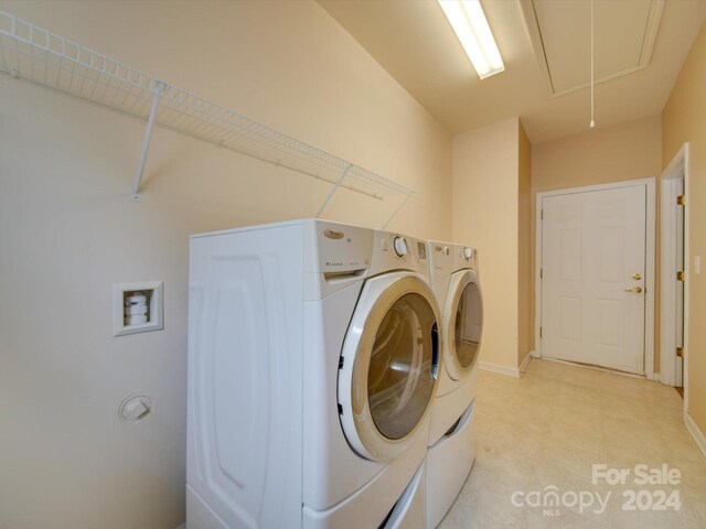 washroom with separate washer and dryer and light tile patterned floors