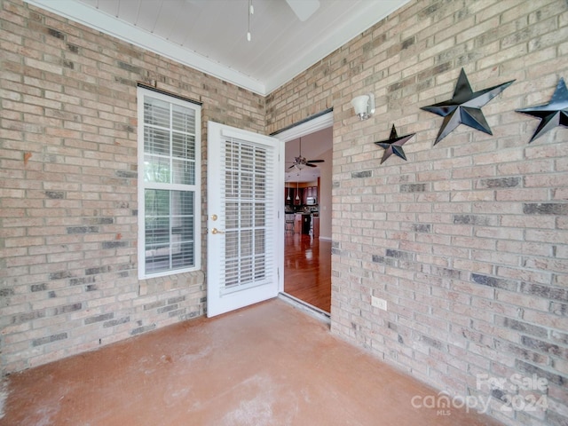 doorway to property with a patio area and ceiling fan