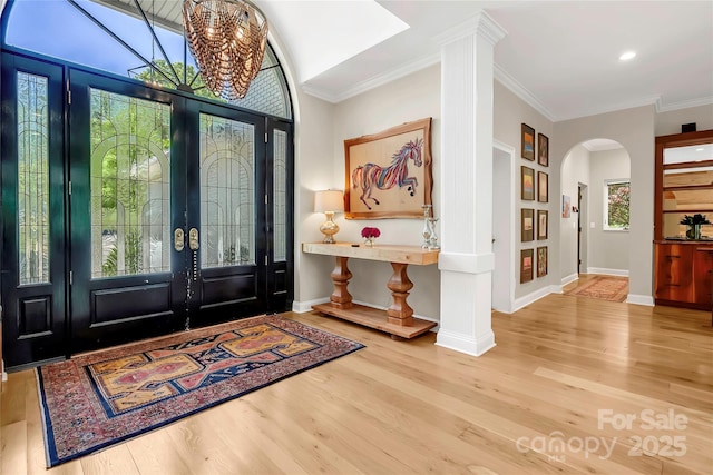 entryway with french doors, ornamental molding, and light hardwood / wood-style floors