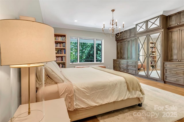 bedroom with access to outside, light wood-type flooring, crown molding, and an inviting chandelier