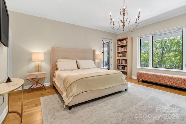 bedroom featuring wood-type flooring, ornamental molding, and a notable chandelier