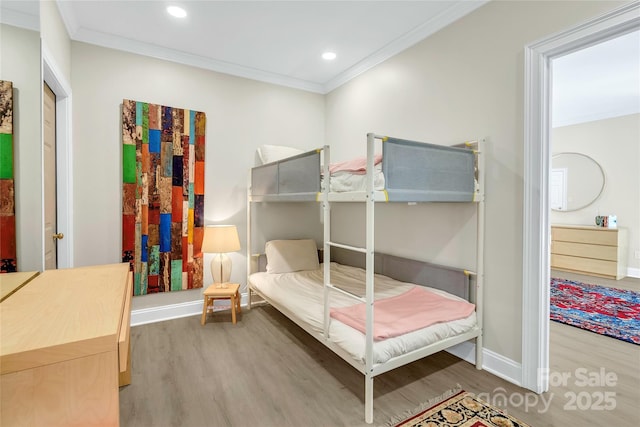 bedroom with wood-type flooring and crown molding