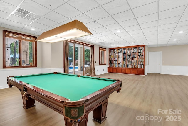 playroom featuring a paneled ceiling, light hardwood / wood-style flooring, and plenty of natural light