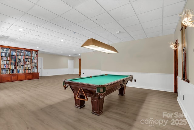 rec room with billiards, a drop ceiling, and hardwood / wood-style flooring