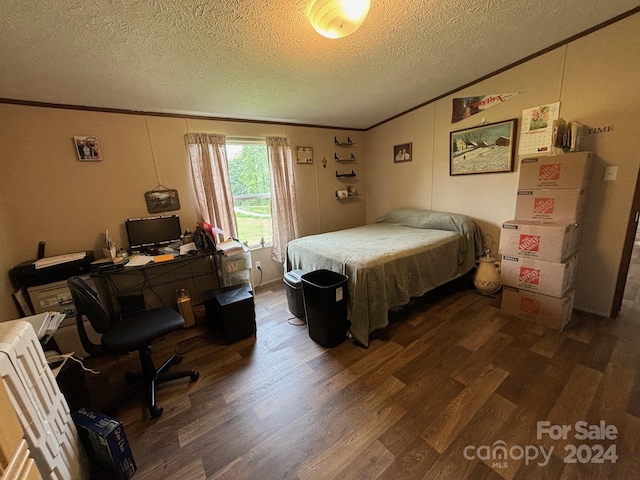 bedroom with a textured ceiling, crown molding, and dark hardwood / wood-style flooring