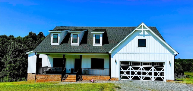 modern farmhouse style home with covered porch and a garage