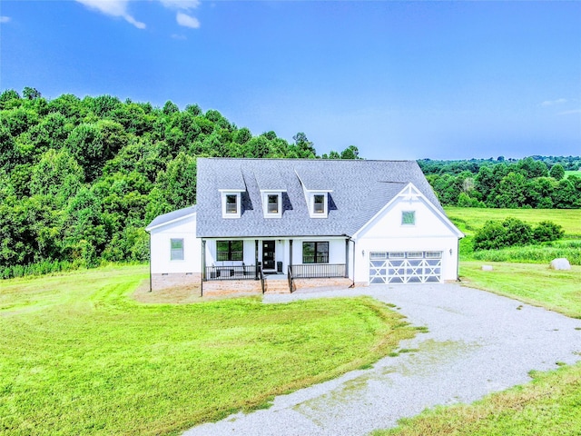 cape cod house featuring covered porch and a front lawn