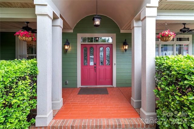 entrance to property featuring ceiling fan and covered porch