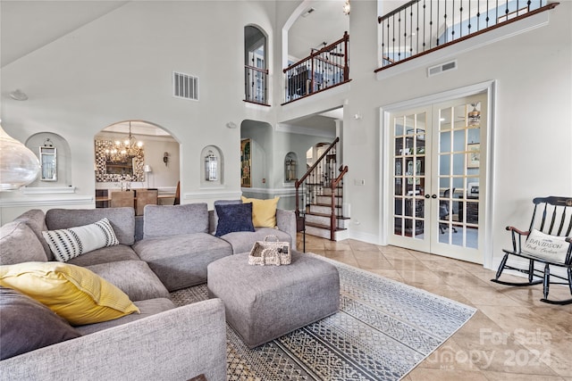 tiled living room with an inviting chandelier and french doors