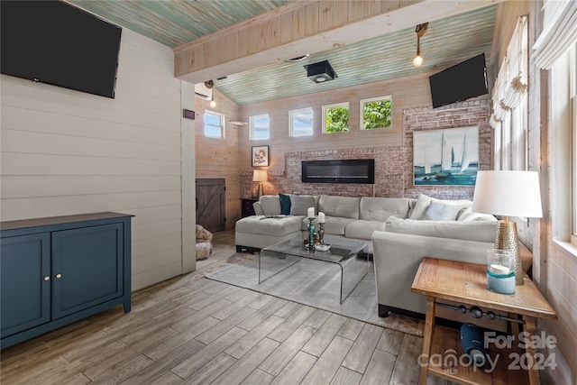 living room featuring lofted ceiling, wooden walls, wooden ceiling, and light hardwood / wood-style floors