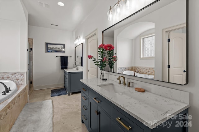 bathroom featuring a relaxing tiled tub and vanity