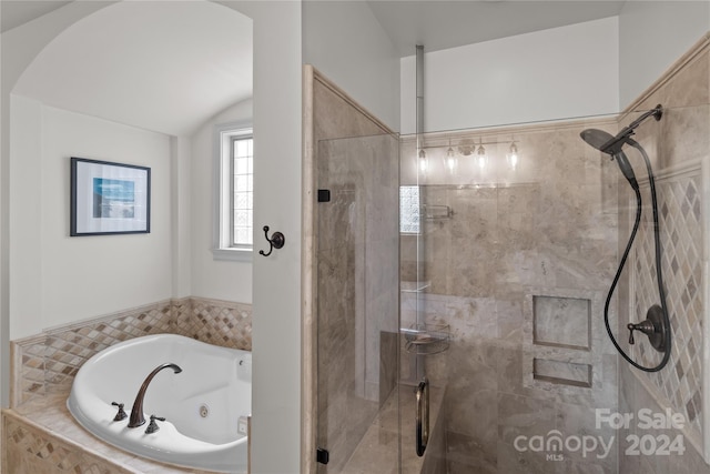 bathroom featuring shower with separate bathtub and vaulted ceiling