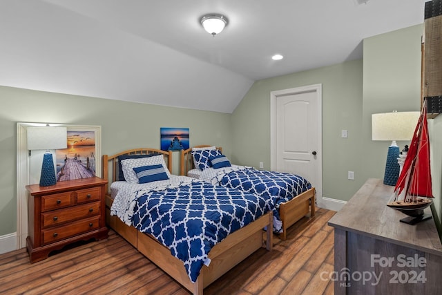 bedroom featuring vaulted ceiling and dark wood-type flooring