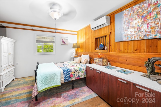 bedroom with ceiling fan, a wall mounted air conditioner, and dark hardwood / wood-style floors