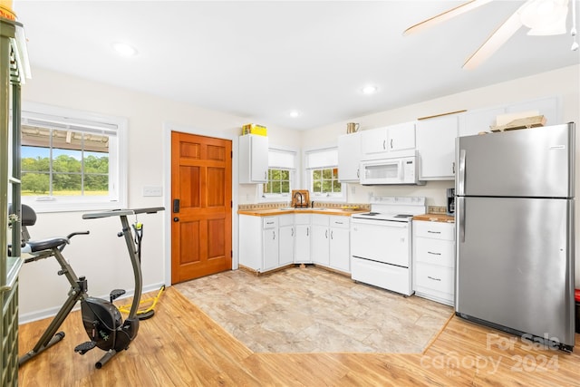 kitchen with sink, white cabinets, white appliances, and light wood-type flooring