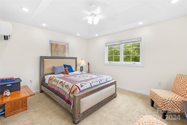 bedroom featuring ceiling fan, light carpet, and an AC wall unit