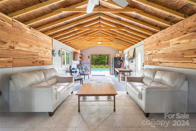 unfurnished living room with lofted ceiling, wooden walls, and light tile patterned floors