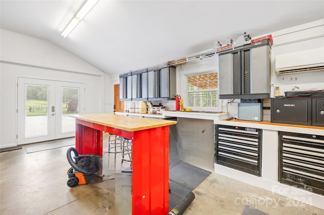 kitchen featuring french doors, wine cooler, lofted ceiling, wooden counters, and a wall mounted AC