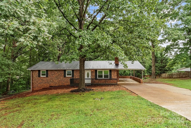 ranch-style house featuring a carport and a front lawn