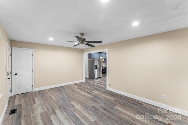 empty room featuring ceiling fan and light hardwood / wood-style flooring