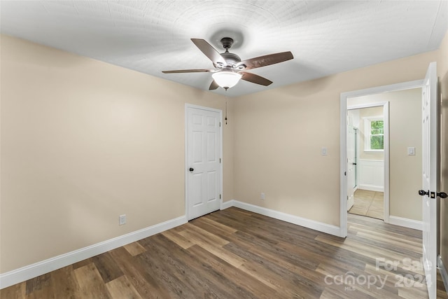 empty room featuring hardwood / wood-style flooring and ceiling fan