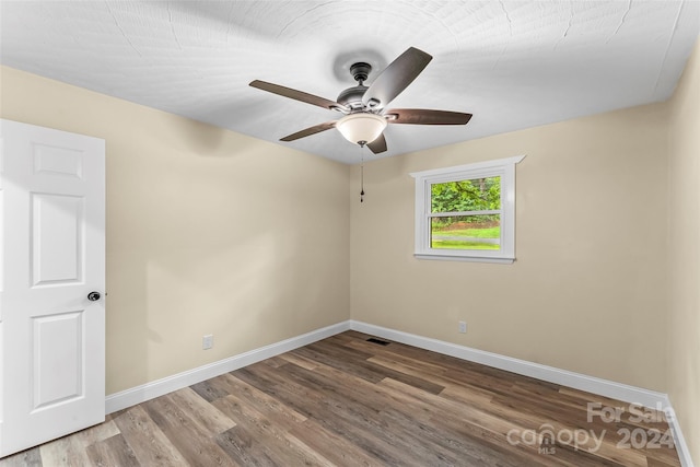 spare room featuring ceiling fan and hardwood / wood-style floors