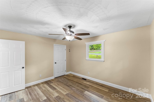 unfurnished bedroom with light hardwood / wood-style floors and ceiling fan