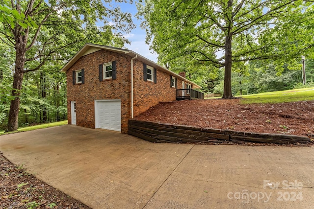 view of side of home with a garage