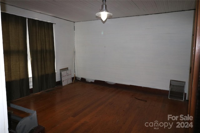 empty room with hardwood / wood-style flooring