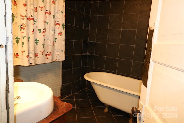 bathroom with sink, tile patterned flooring, and tile walls