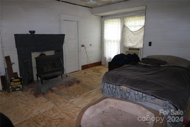 bedroom with a wood stove and cooling unit