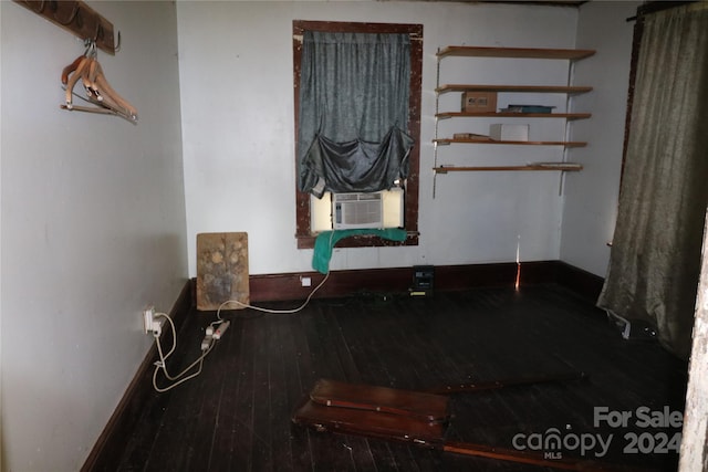 empty room featuring cooling unit and hardwood / wood-style flooring