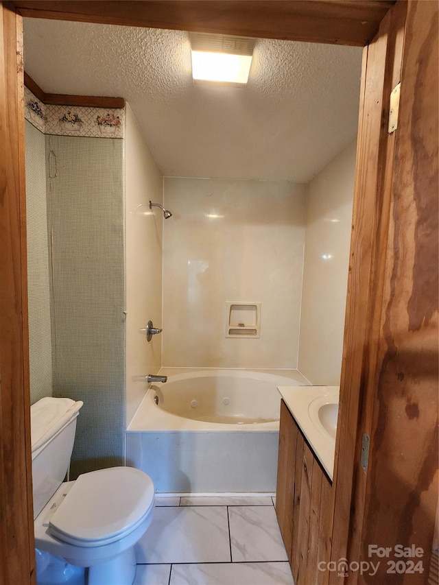 full bathroom featuring vanity, toilet, bathing tub / shower combination, and a textured ceiling