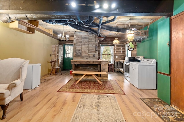 basement featuring washer / clothes dryer, white refrigerator, and light wood-type flooring