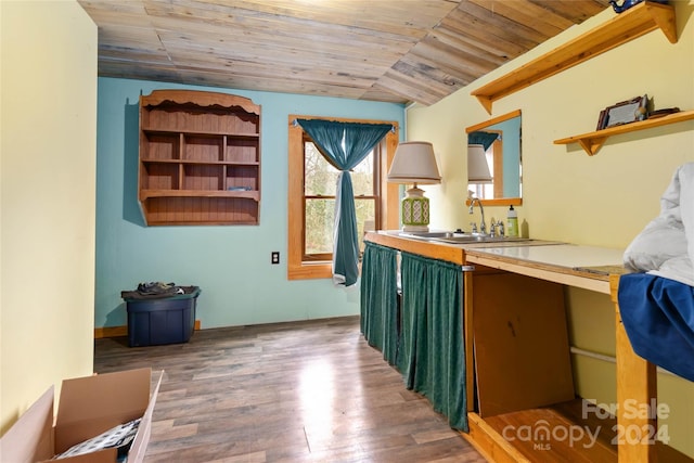 interior space featuring dark hardwood / wood-style flooring, wet bar, and wooden ceiling