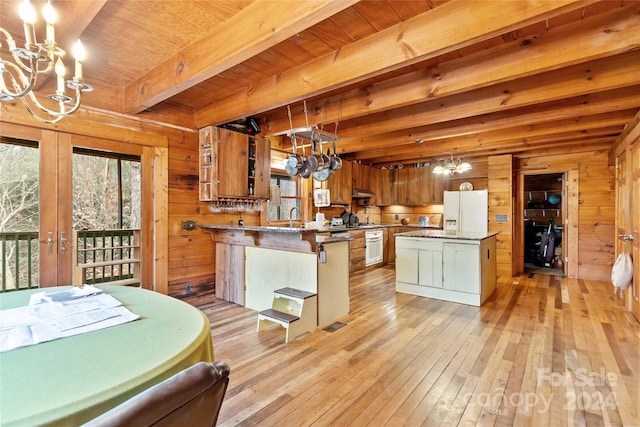 902 Coldwater Ct, Concord, NC 28025 - kitchen with a chandelier, white appliances, light wood-style floors, wooden walls, and a peninsula
