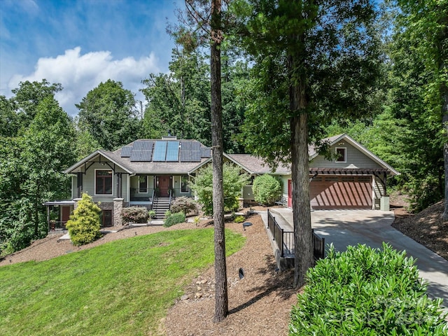 craftsman inspired home with a front lawn, solar panels, covered porch, and a garage