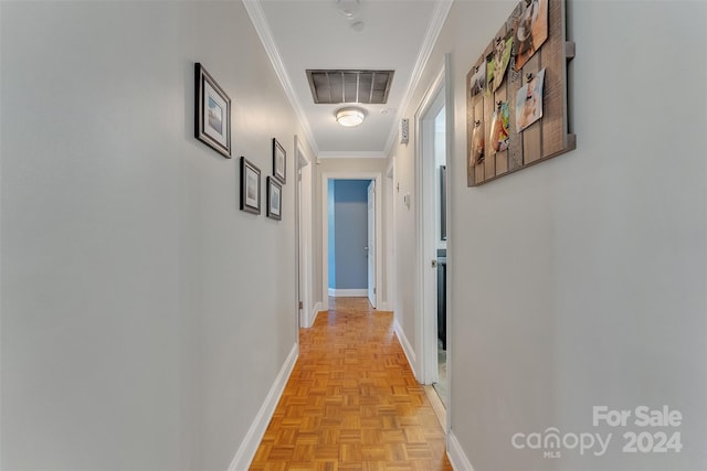 hallway featuring crown molding and light parquet floors