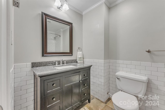 bathroom featuring crown molding, tile walls, vanity, and toilet