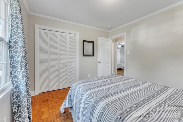 bedroom featuring crown molding, parquet floors, and a closet