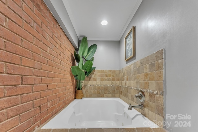 bathroom featuring a relaxing tiled tub, crown molding, and brick wall