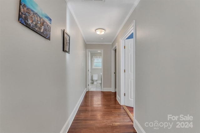 hall featuring crown molding and hardwood / wood-style flooring